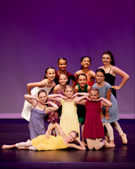 Dancers leaping with joy in a modern dance class